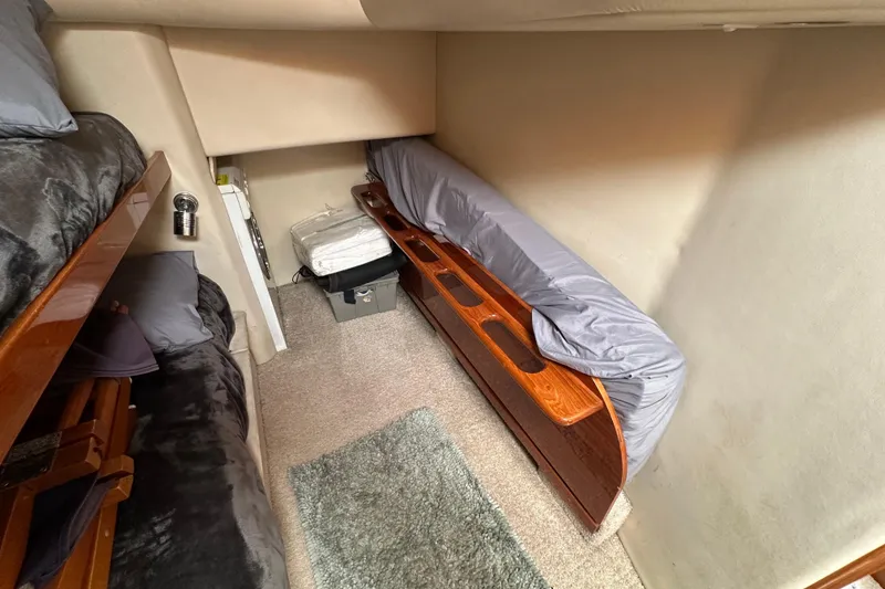 Slide: The Image of Interior cabin of 2002 Riviera 40 Flybridge yacht with bunk beds and storage. - 45
