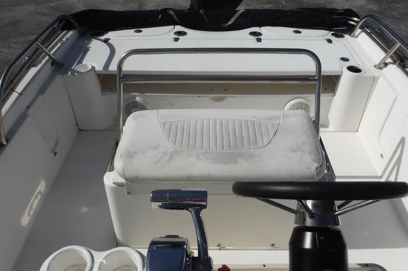 Slide: The Image of 2007 Boston Whaler 180 Dauntless boat interior with steering wheel and seating area. - 12