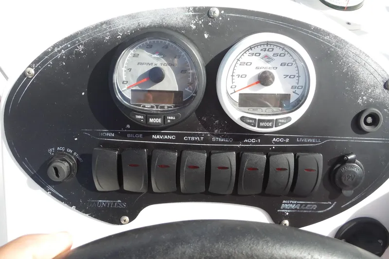 Slide: The Image of Dashboard of a 2007 Boston Whaler 180 Dauntless boat with gauges and switches. - 13
