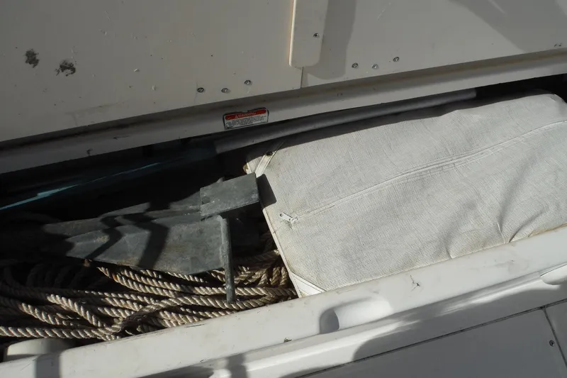 Slide: The Image of Storage compartment of a 2007 Boston Whaler 180 Dauntless with anchor and rope. - 15
