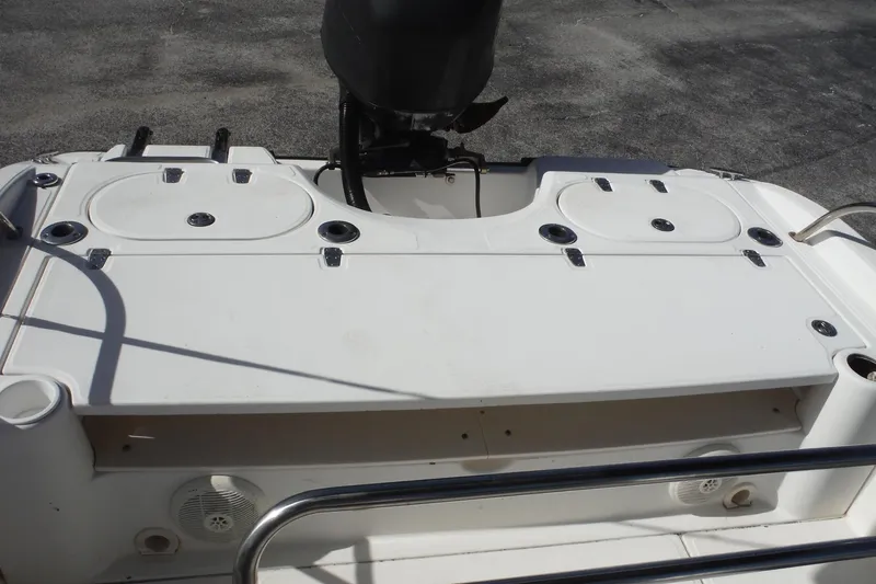 Slide: The Image of 2007 Boston Whaler 180 Dauntless boat deck with storage compartments and motor. - 24
