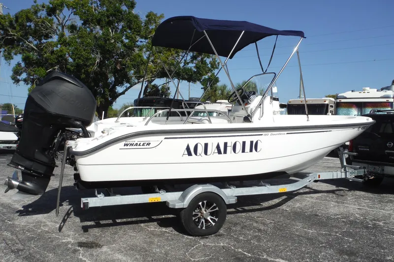 Slide: The Image of 2007 Boston Whaler 180 Dauntless boat on trailer with canopy, labeled "Aquaholic." - 25