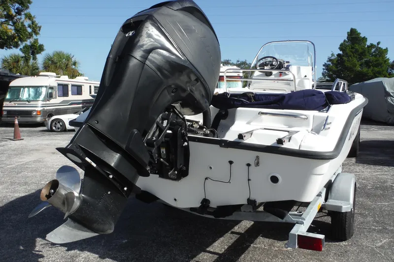 Slide: The Image of 2007 Boston Whaler 180 Dauntless boat on trailer, featuring powerful outboard motor. - 3