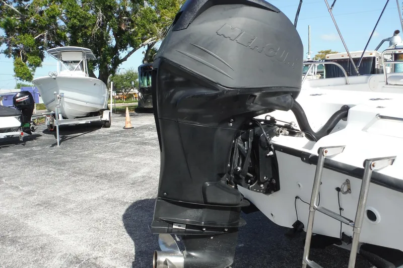 Slide: The Image of 2007 Boston Whaler 180 Dauntless with Mercury outboard motor, parked outdoors. - 30