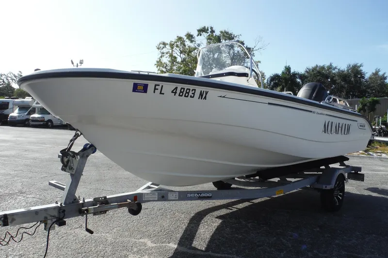 Slide: The Image of 2007 Boston Whaler 180 Dauntless boat on trailer, parked outdoors. - 5