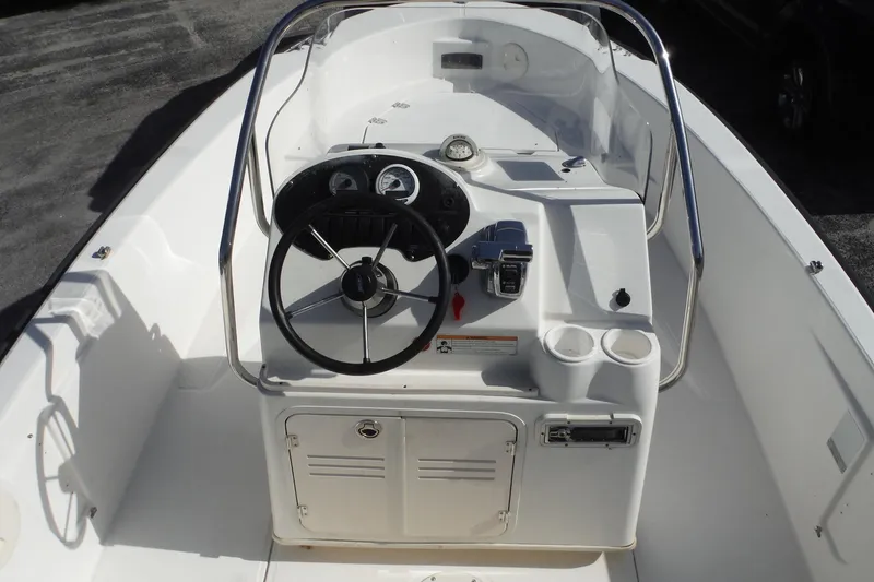 Slide: The Image of 2007 Boston Whaler 180 Dauntless boat console with steering wheel and controls. - 8