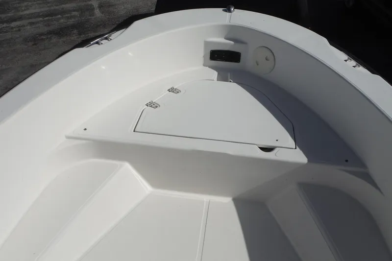 Slide: The Image of 2007 Boston Whaler 180 Dauntless boat interior, featuring a clean, white deck and storage compartment. - 9