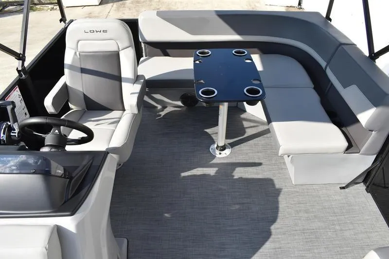 Slide: The Image of 2026 Lowe LS 170 boat interior with gray seating and a central table. - 22
