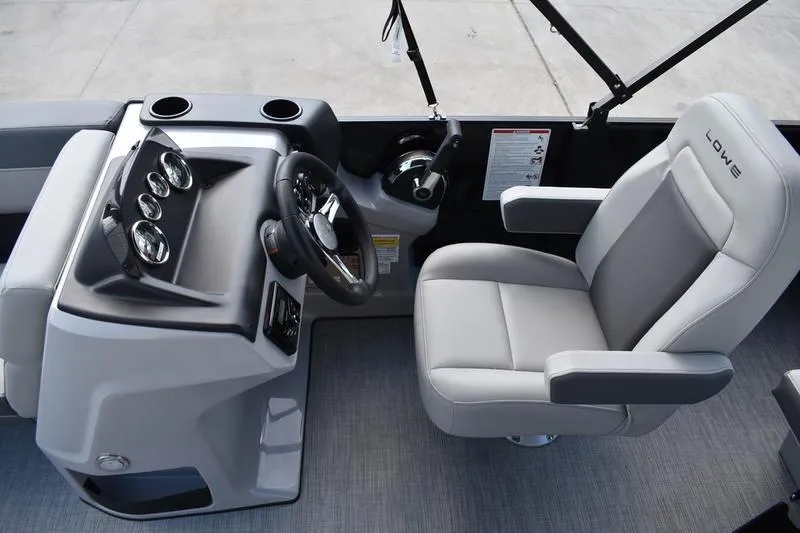 Slide: The Image of 2026 Lowe LS 170 boat interior with steering console and comfortable seating. - 23