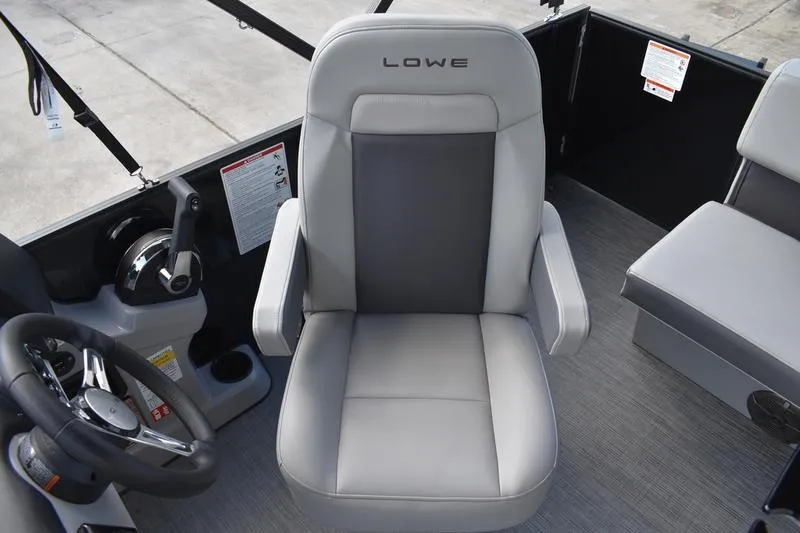 Slide: The Image of Captain's chair in 2026 Lowe LS 170 boat, featuring sleek gray upholstery and modern design. - 25