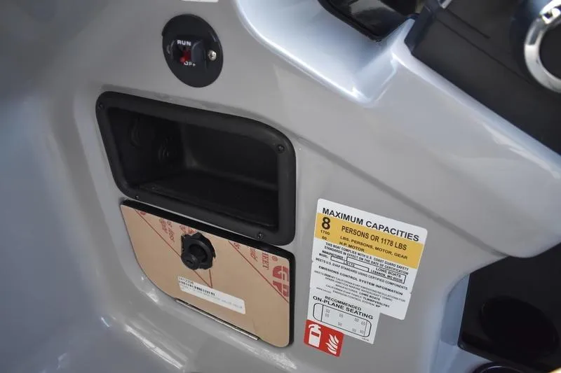 Slide: The Image of Close-up of 2026 Lowe LS 170 power outlets in a black compartment. - 28