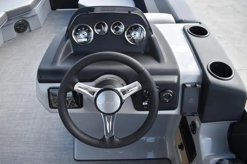 Slide: The Image of Steering console of 2026 Lowe LS 170 boat with gauges and cup holders. - 29