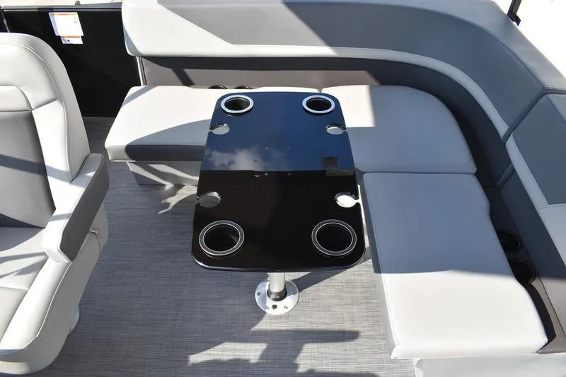 Slide: The Image of Luxurious seating area on 2026 Lowe LS 170 boat with sleek black table and cup holders. - 33