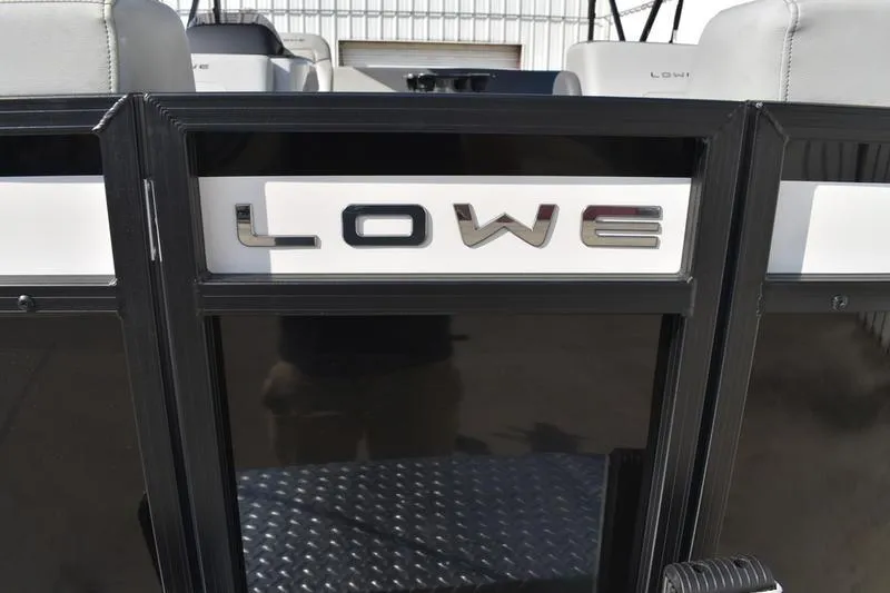 Slide: The Image of 2026 Lowe LS 170 boat with sleek black and white design, featuring prominent logo. - 9