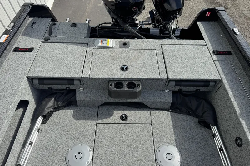 Slide: The Image of 2026 Lund 2075 Impact XS boat interior with storage compartments and dual motors. - 11