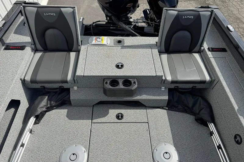 Slide: The Image of 2026 Lund 2075 Impact XS boat interior with two gray seats and storage compartments. - 12