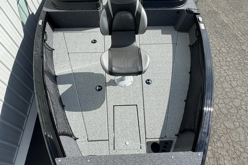 Slide: The Image of 2026 Lund 2075 Impact XS boat interior with gray flooring and central seat. - 4
