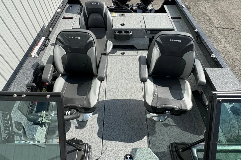 Slide: The Image of 2026 Lund 2075 Impact XS boat interior with two black seats and console. - 7