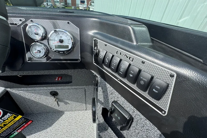 Slide: The Image of Dashboard of 2026 Lund 2075 Impact XS boat with gauges and control switches. - 9