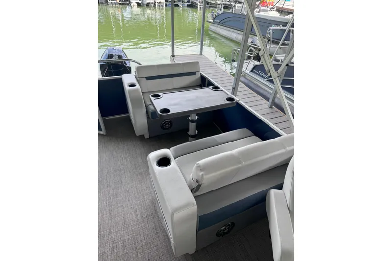Slide: The Image of 2024 Godfrey SWEETWATER 2486 DT pontoon boat interior with seating and table. - 3