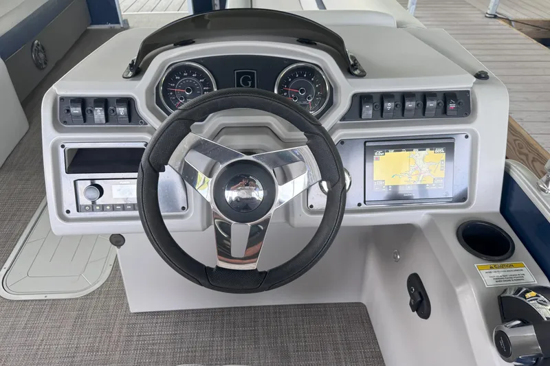Slide: The Image of 2024 Godfrey SWEETWATER 2486 DT dashboard with steering wheel and navigation display. - 7