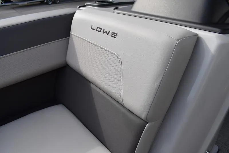 Slide: The Image of 2026 Lowe LS 210 WT boat interior with cushioned seating and sleek design. - 11