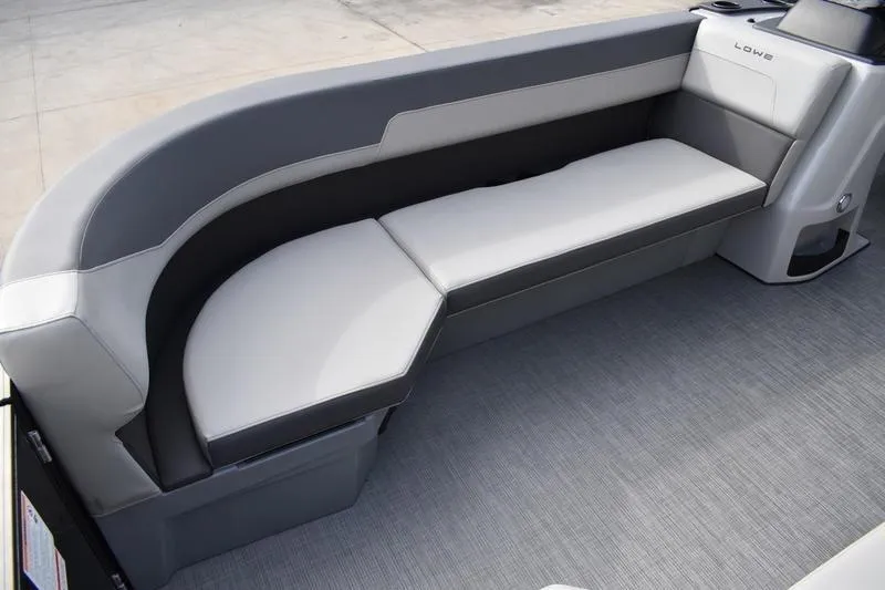 Slide: The Image of Interior seating area of 2026 Lowe LS 210 WT boat, featuring curved bench design. - 14