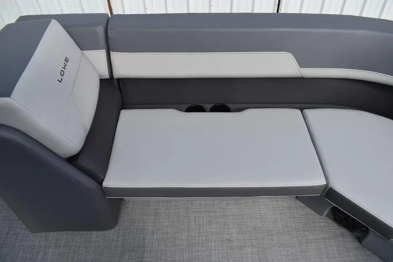 Slide: The Image of 2026 Lowe LS 210 WT boat seat storage compartment with cup holders. - 19