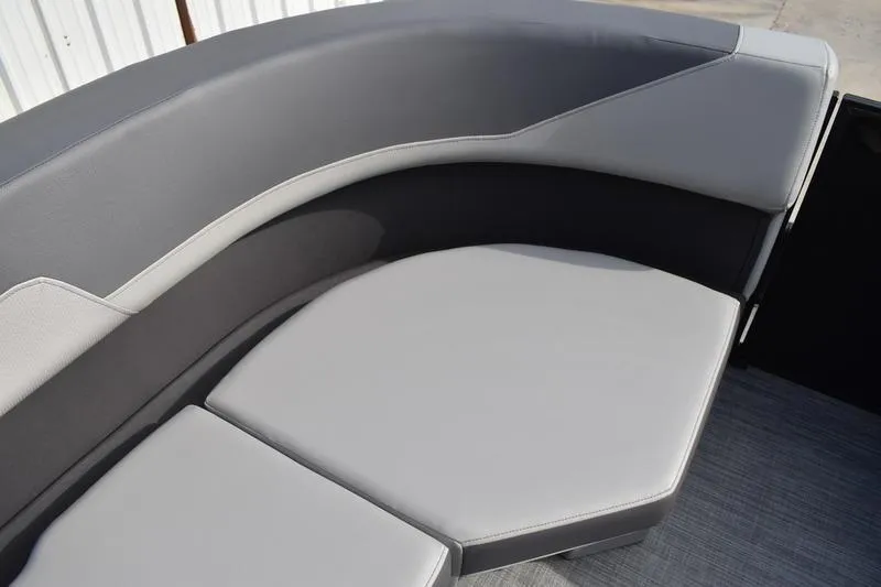 Slide: The Image of 2026 Lowe LS 210 WT boat storage compartment with gray seating and speaker. - 21