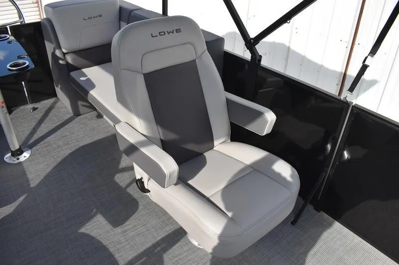 Slide: The Image of 2026 Lowe LS 210 WT boat interior with steering wheel and comfortable seating. - 28