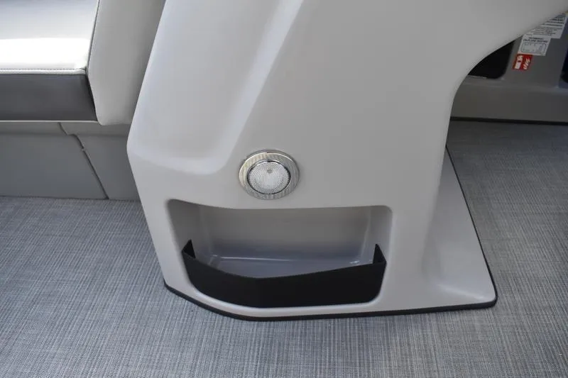 Slide: The Image of Interior view of 2026 Lowe LS 210 WT boat, showing capacity label and storage compartment. - 30