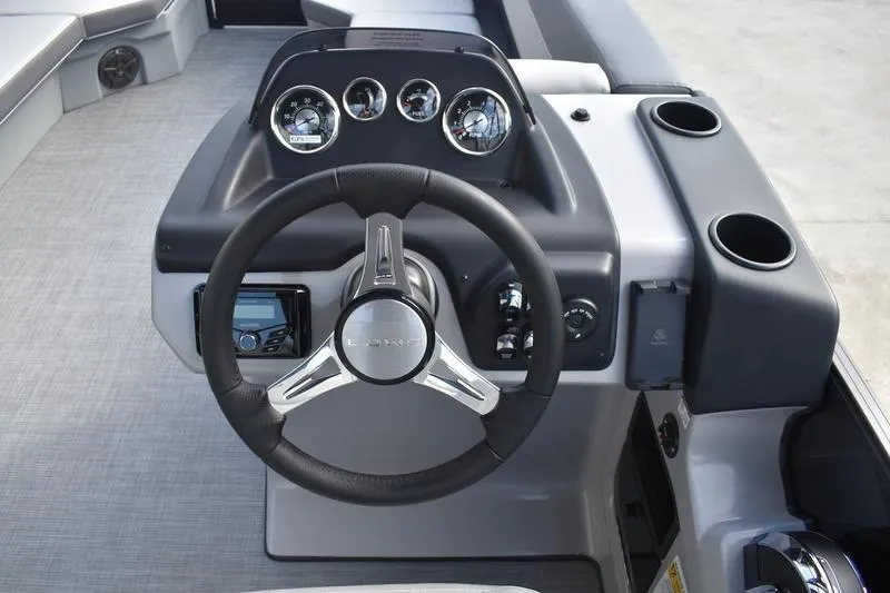Slide: The Image of Control panel of 2026 Lowe LS 210 WT boat with cup holders and switches. - 34