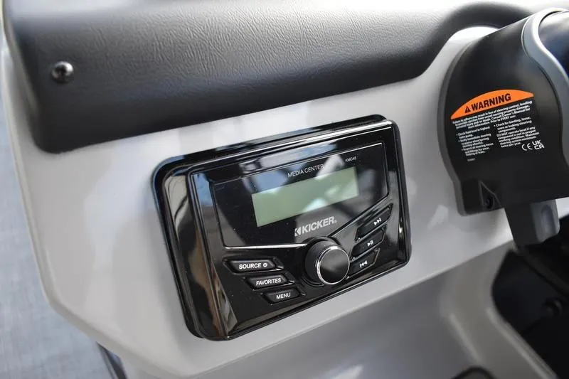 Slide: The Image of Interior of 2026 Lowe LS 210 WT boat with seating and table featuring cup holders. - 35