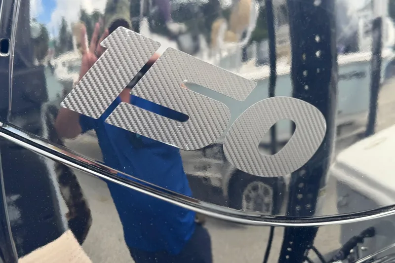 Slide: The Image of Carbon fiber "150" decal on Piranha B2000, 2026 model, reflecting surroundings. - 12