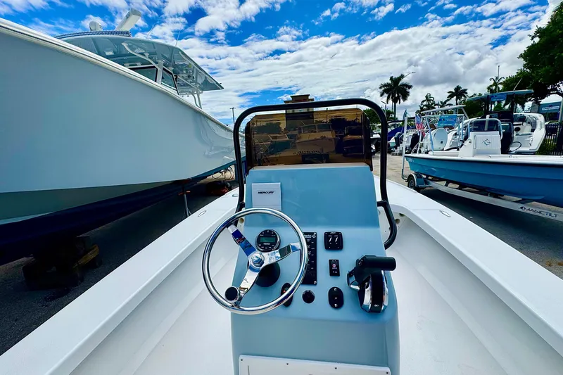 Slide: The Image of Piranha B2000 boat dashboard with steering wheel, surrounded by other boats, under a blue sky. - 3