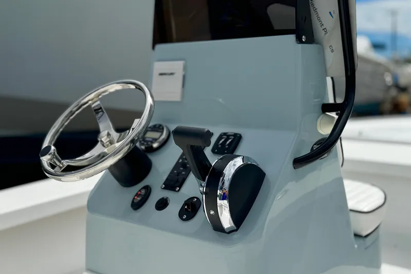 Slide: The Image of Steering console of 2026 Piranha B2000 boat with chrome accents and controls. - 4
