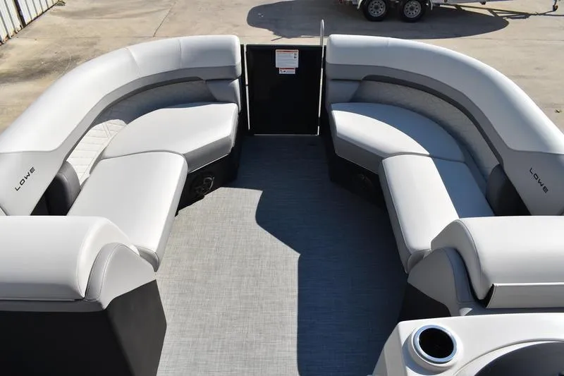 Slide: The Image of 2026 Lowe SS 230 boat seat with open storage compartment and cup holders. - 16