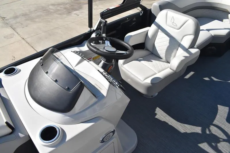 Slide: The Image of 2026 Lowe SS 230 boat interior with gray seating and steering wheel. - 24