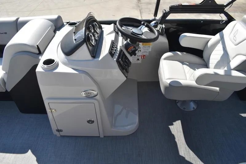 Slide: The Image of 2026 Lowe SS 230 boat interior with steering console and comfortable seating. - 26
