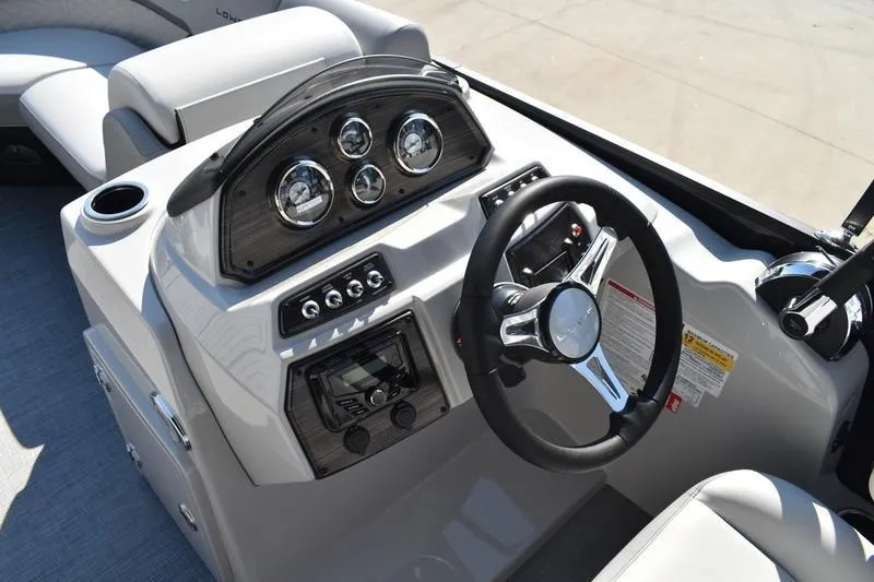 Slide: The Image of 2026 Lowe SS 230 boat dashboard with steering wheel and instrument panel. - 29