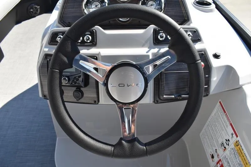 Slide: The Image of Steering wheel of 2026 Lowe SS 230 boat, featuring modern dashboard controls. - 30