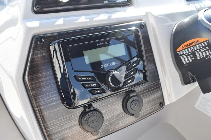 Slide: The Image of Control panel of 2026 Lowe SS 230 boat featuring Kicker media center and USB ports. - 31