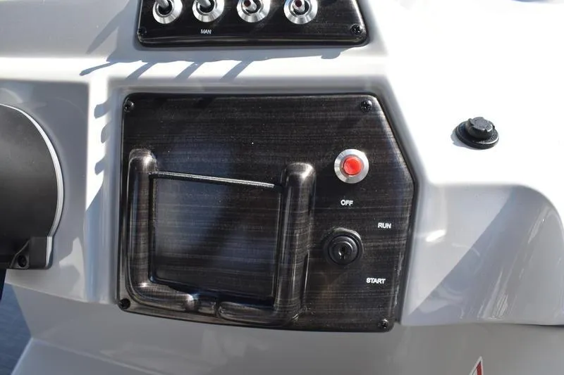 Slide: The Image of Dashboard of 2026 Lowe SS 230 boat with gauges and control switches. - 32