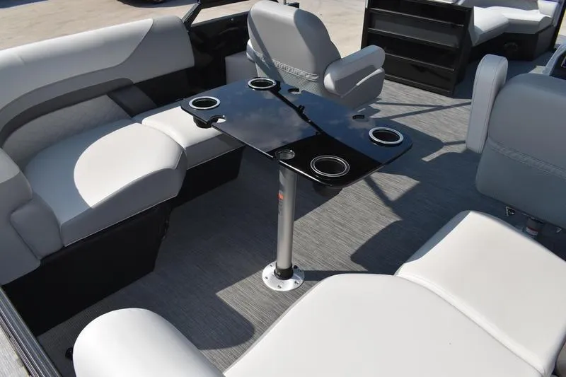 Slide: The Image of 2026 Lowe SS 230 boat interior with gray seating and a black table featuring cup holders. - 36