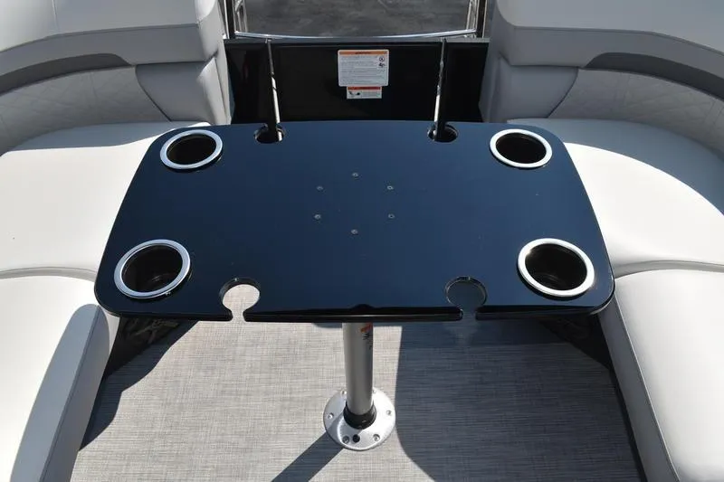 Slide: The Image of Interior of 2026 Lowe SS 230 boat with sleek black table and cushioned seating. - 38