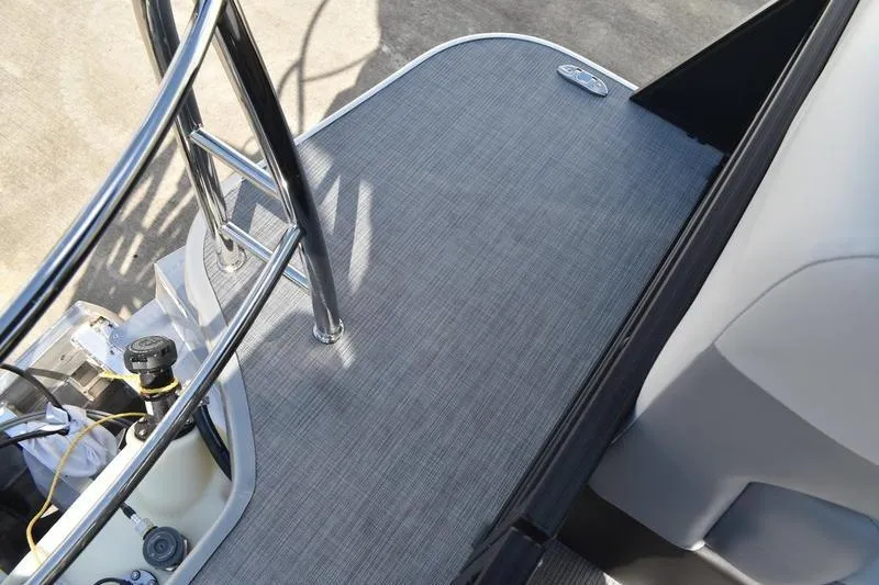 Slide: The Image of 2026 Lowe SS 230 boat seat storage compartment with cup holder, featuring modern upholstery. - 46