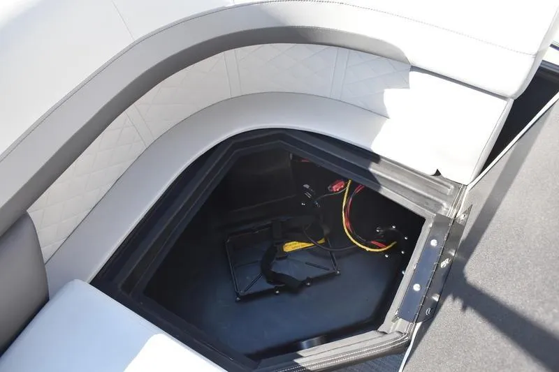 Slide: The Image of Under-seat storage compartment in 2026 Lowe SS 230 boat, featuring wiring and battery holder. - 47