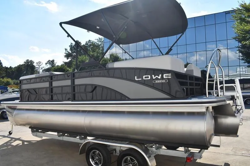 Slide: The Image of 2026 Lowe SS 230 pontoon boat with ladder, parked on a trailer. - 6