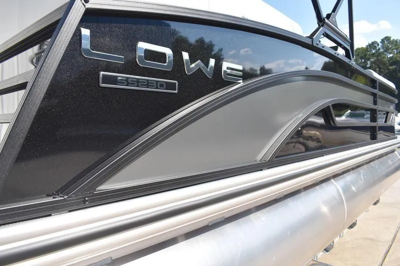 Slide: The Image of 2026 Lowe SS 230 pontoon boat on trailer, featuring sleek design and canopy. - 8