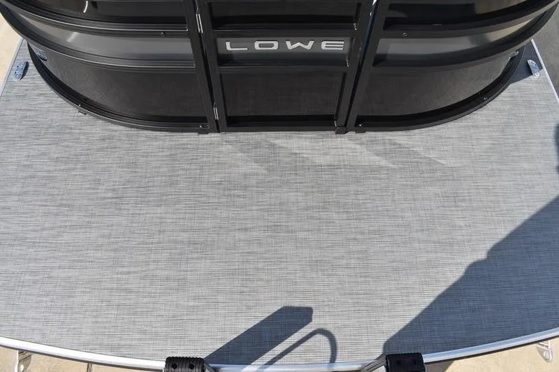 Slide: The Image of 2026 Lowe SS 230 pontoon boat on trailer, sleek design, black canopy, outdoor setting. - 9